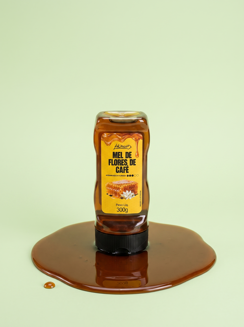 Bisnaga de Mel de Flores de Café Honup 300g sobre fundo verde claro